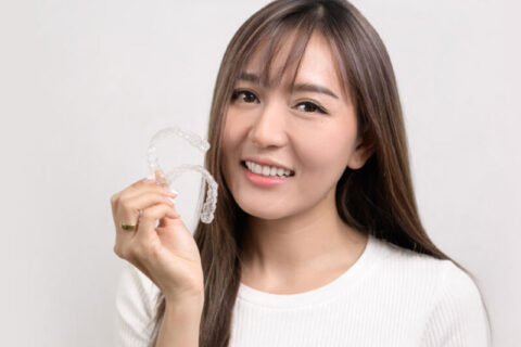 A women showing her Invisalign