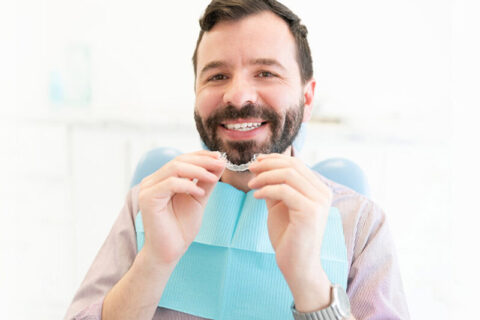 A women showing her Invisalign