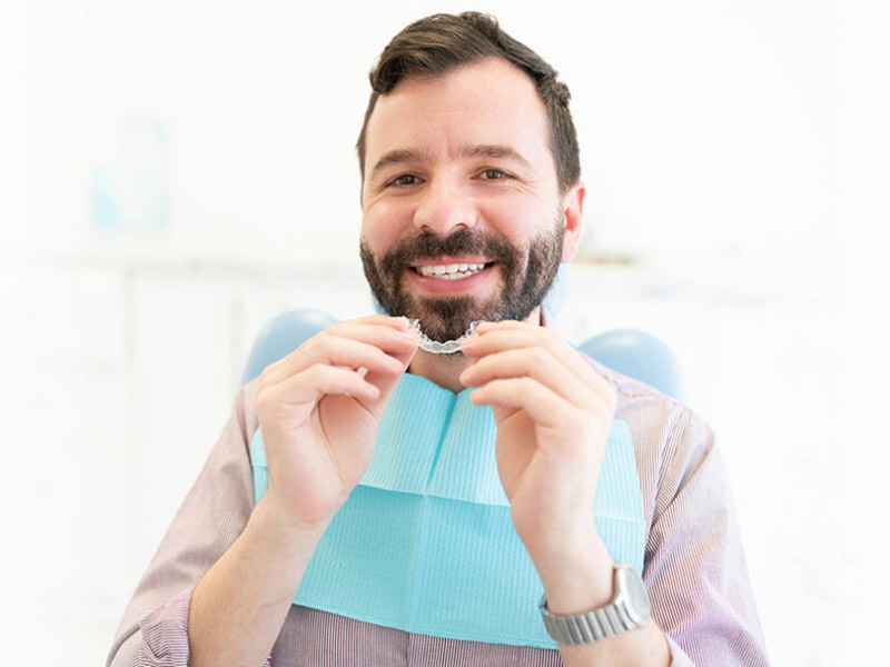 A women showing her Invisalign